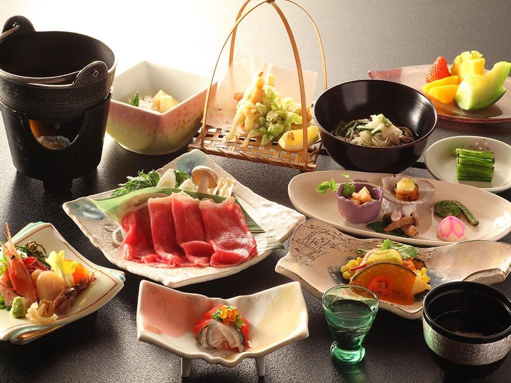 Traditional Japanese dinner with sashimi, hotpot, and side dishes at Ryokan Biyu no Yado