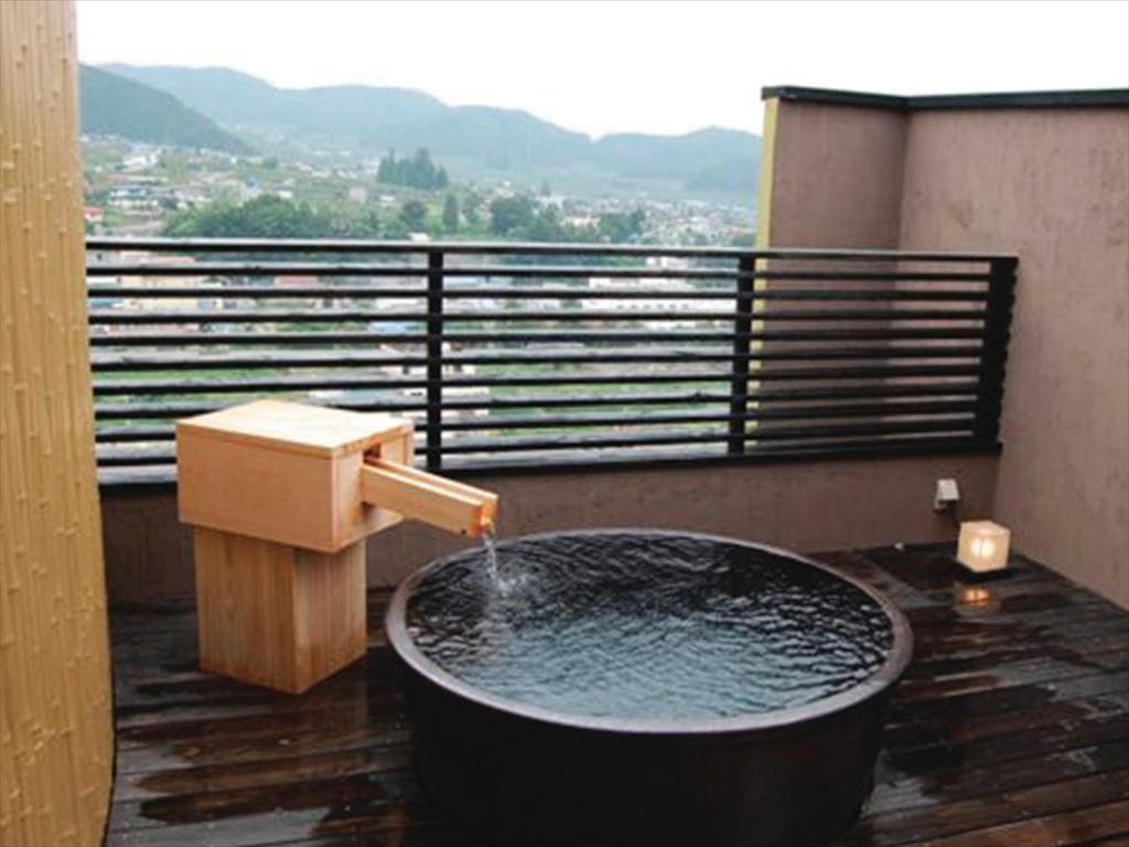 Private round outdoor onsen bath with town view at Ryokan Biyu no Yado