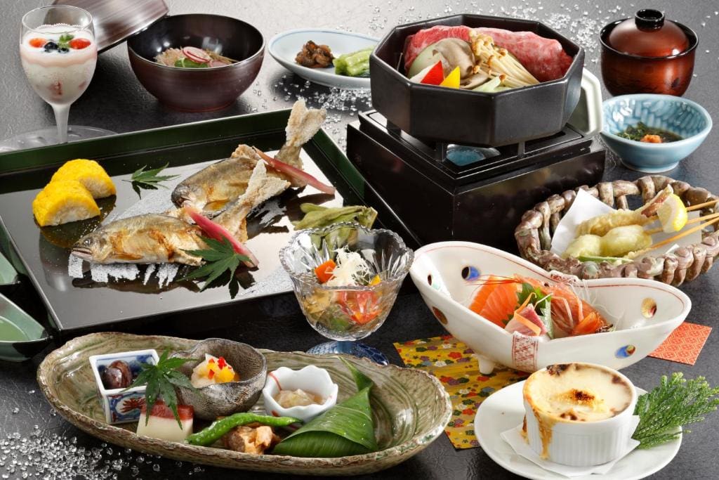 Traditional kaiseki dinner with sashimi, grilled fish, hotpot, and side dishes at Wafu-no-Yado Masuya