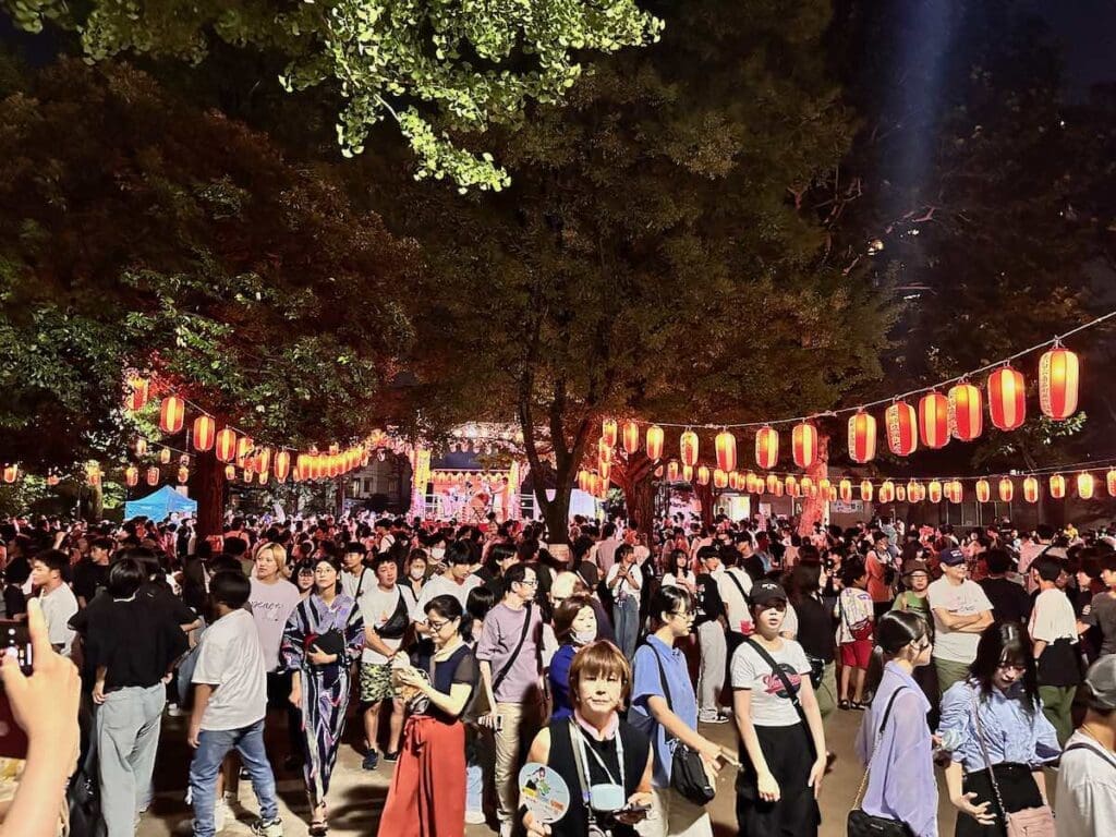 Japanese summer festival with lanterns, food stands, and obon dance