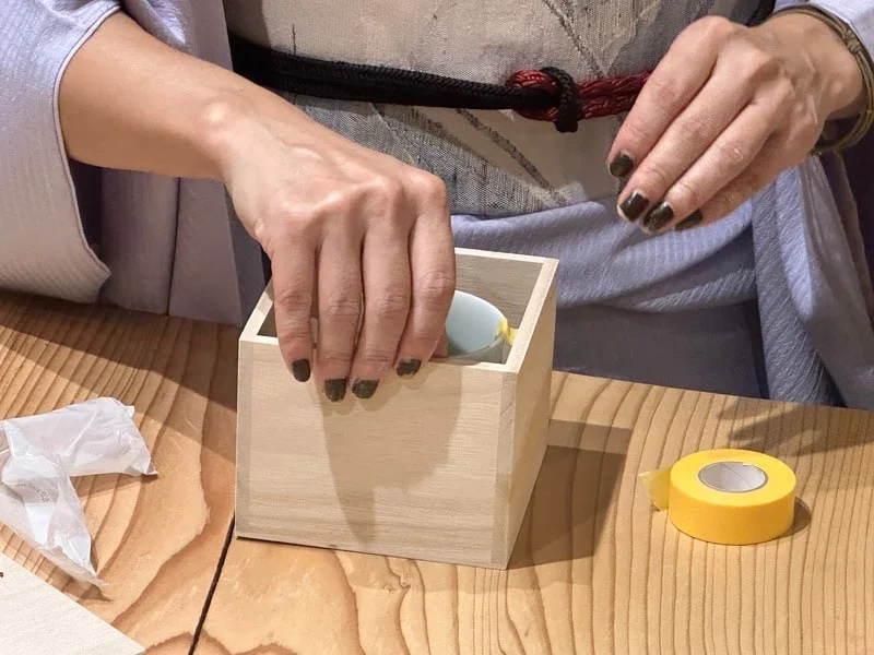 Broken Japanese pottery up repaired with kintsugi being packed for shipping