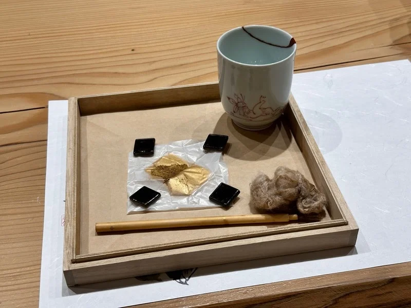 Gold powder to be applied on broken cup at kintsugi experience