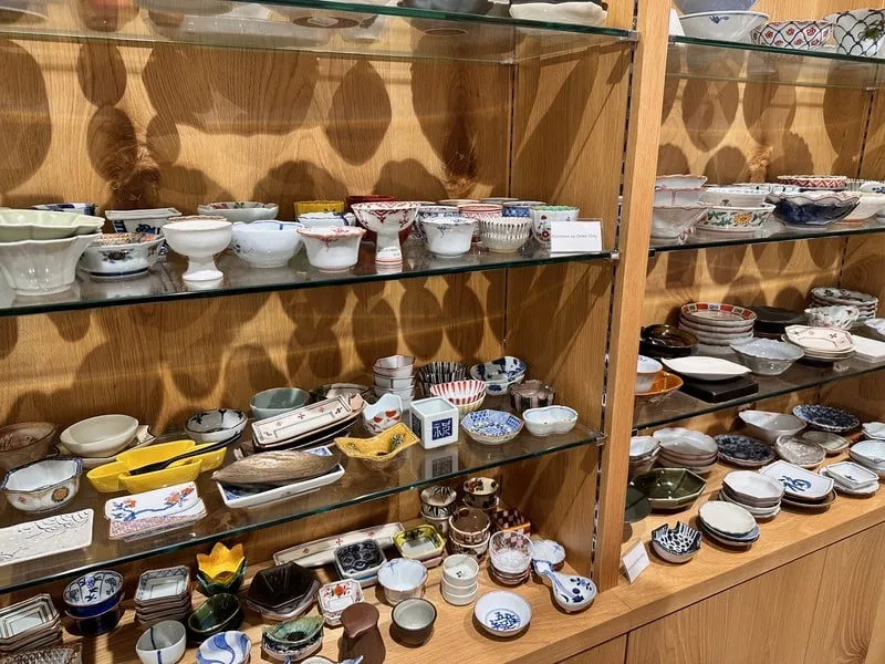 Pottery on display on shelves at Utsuwa Omusubi HANARE in Omotesando, Tokyo