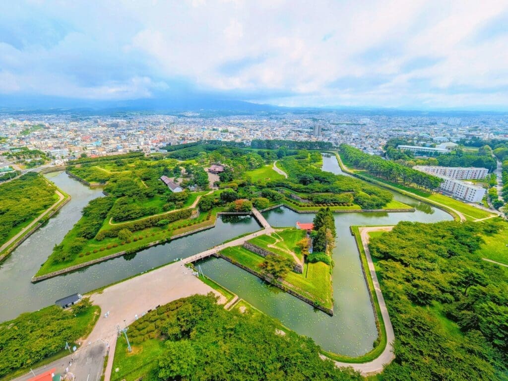 Aerial view of Goryokaku star-shaped fort with moat and surrounding greenery in Hakodate, Hokkaido
