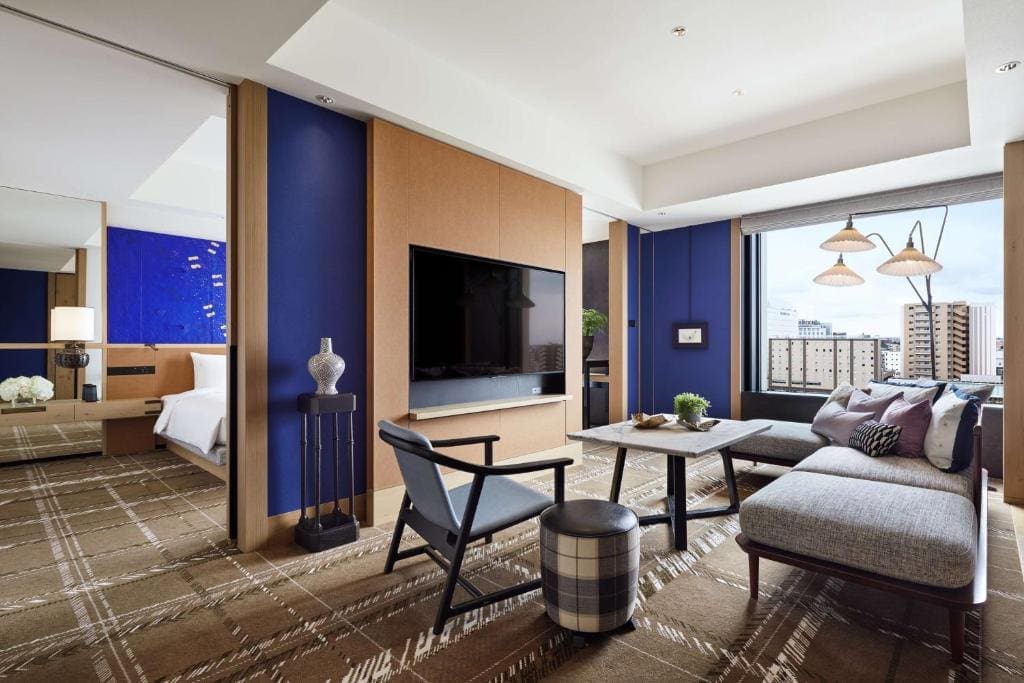 Hyatt Centric Kanazawa hotel suite living area with sofa and city view