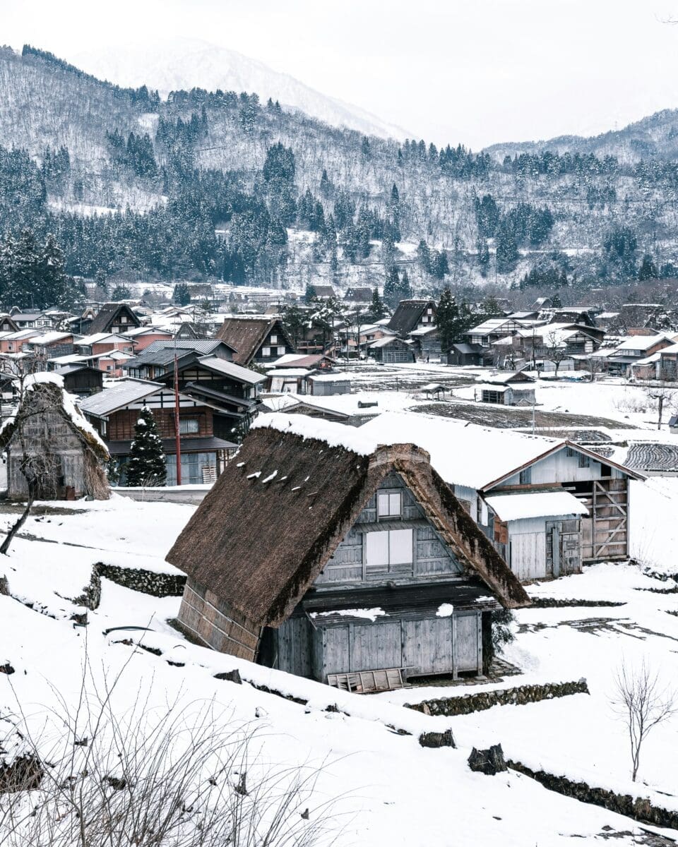 Traditional thatched-roof farmhouses covered in snow at Shirakawa-go village in Japan