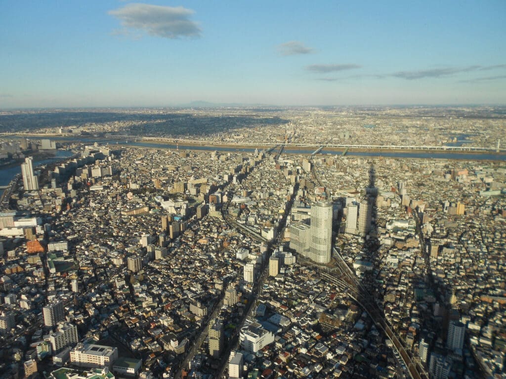 Aerial view of Tokyo from Tokyo Skytree showing dense urban buildings and the Sumida River