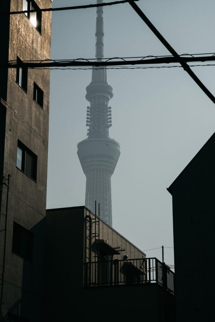 Tokyo Skytree framed by silhouettes of urban buildings and overhead wires