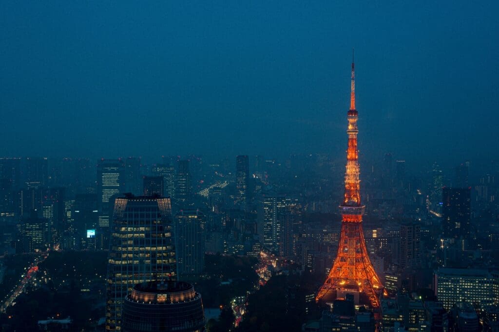 Tokyo Tower illuminated at night rising above Tokyo city skyline