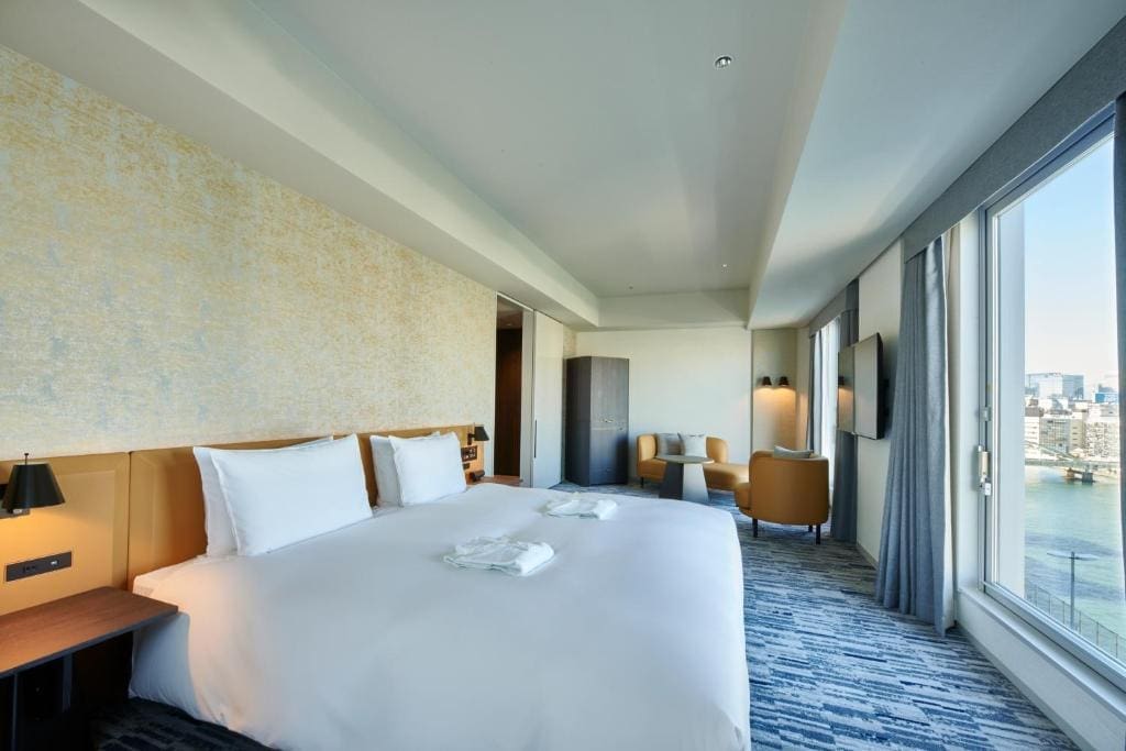 Spacious hotel room with king bed and Sumida River view at The Gate Hotel Ryogoku
