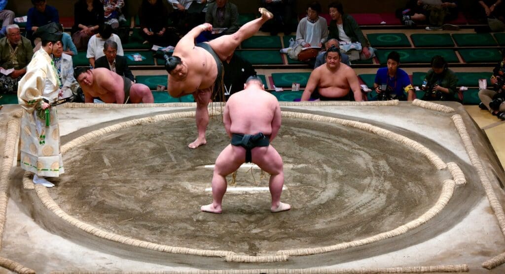 Sumo wrestlers performing pre-match ritual in dohyo ring at Ryogoku Kokugikan arena in Tokyo