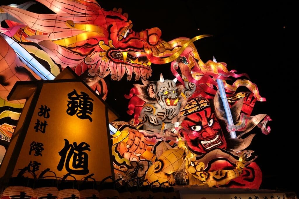 Illuminated warrior and demon float at the Aomori Nebuta Festival in Aomori, Japan at night