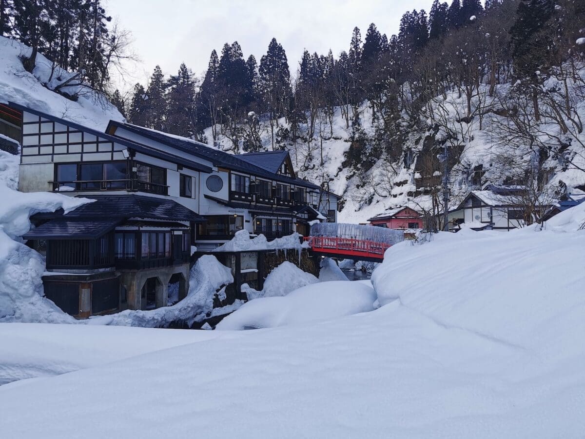 Snowy bridge scene at Ginzan Onsen