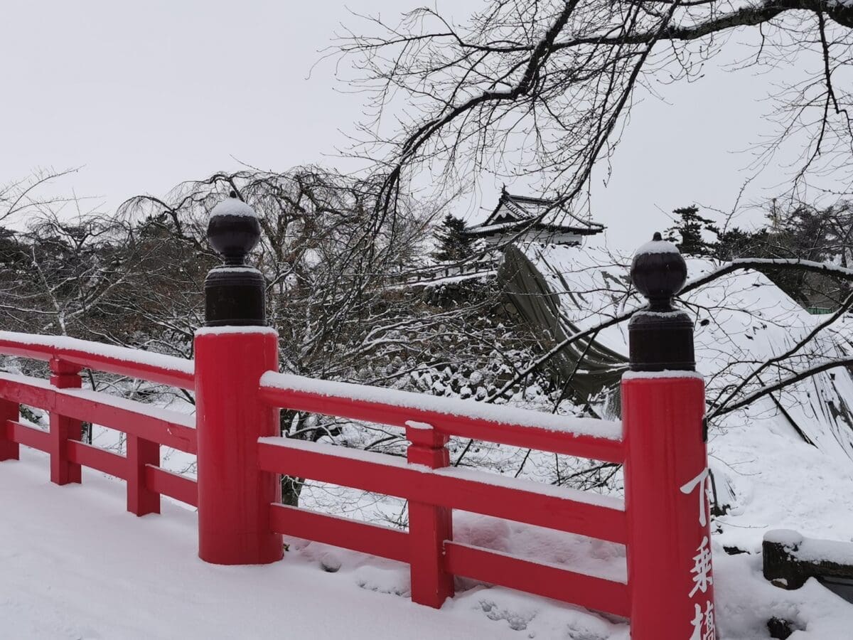 Red bridge at Hirosaki Castle in winter